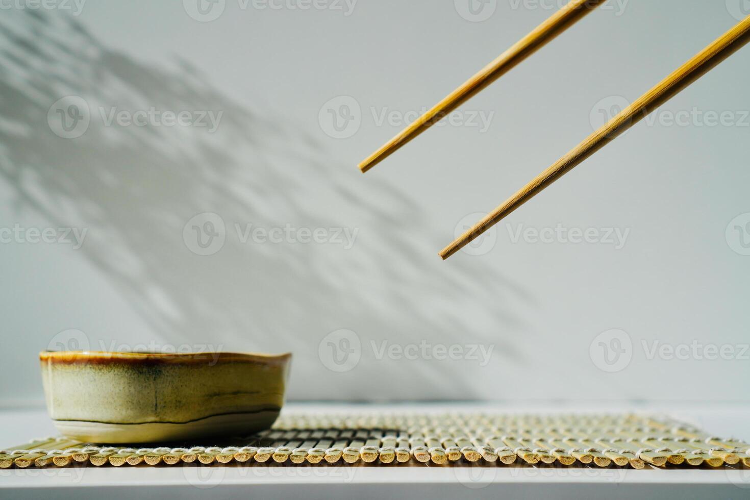 chopsticks and bowl of soy sauce photo