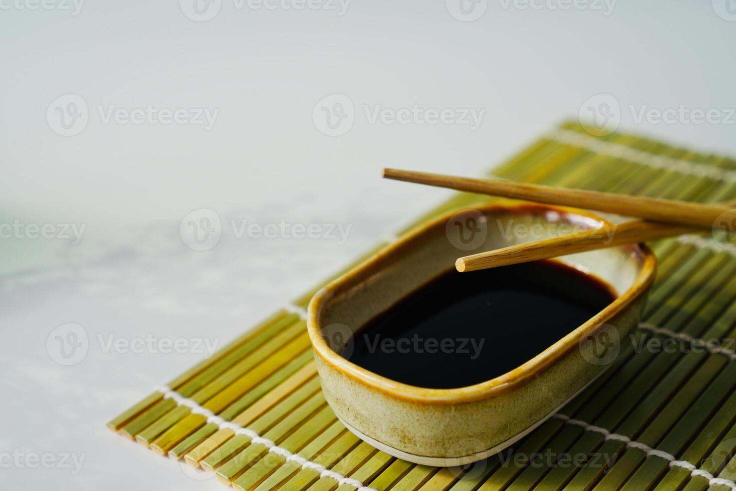 chopsticks and bowl of soy sauce photo