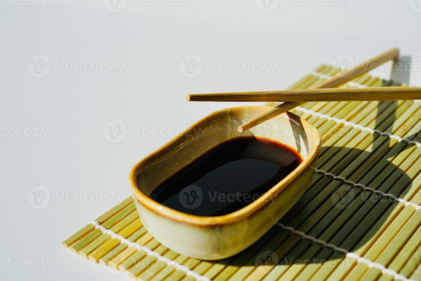 chopsticks and bowl of soy sauce photo