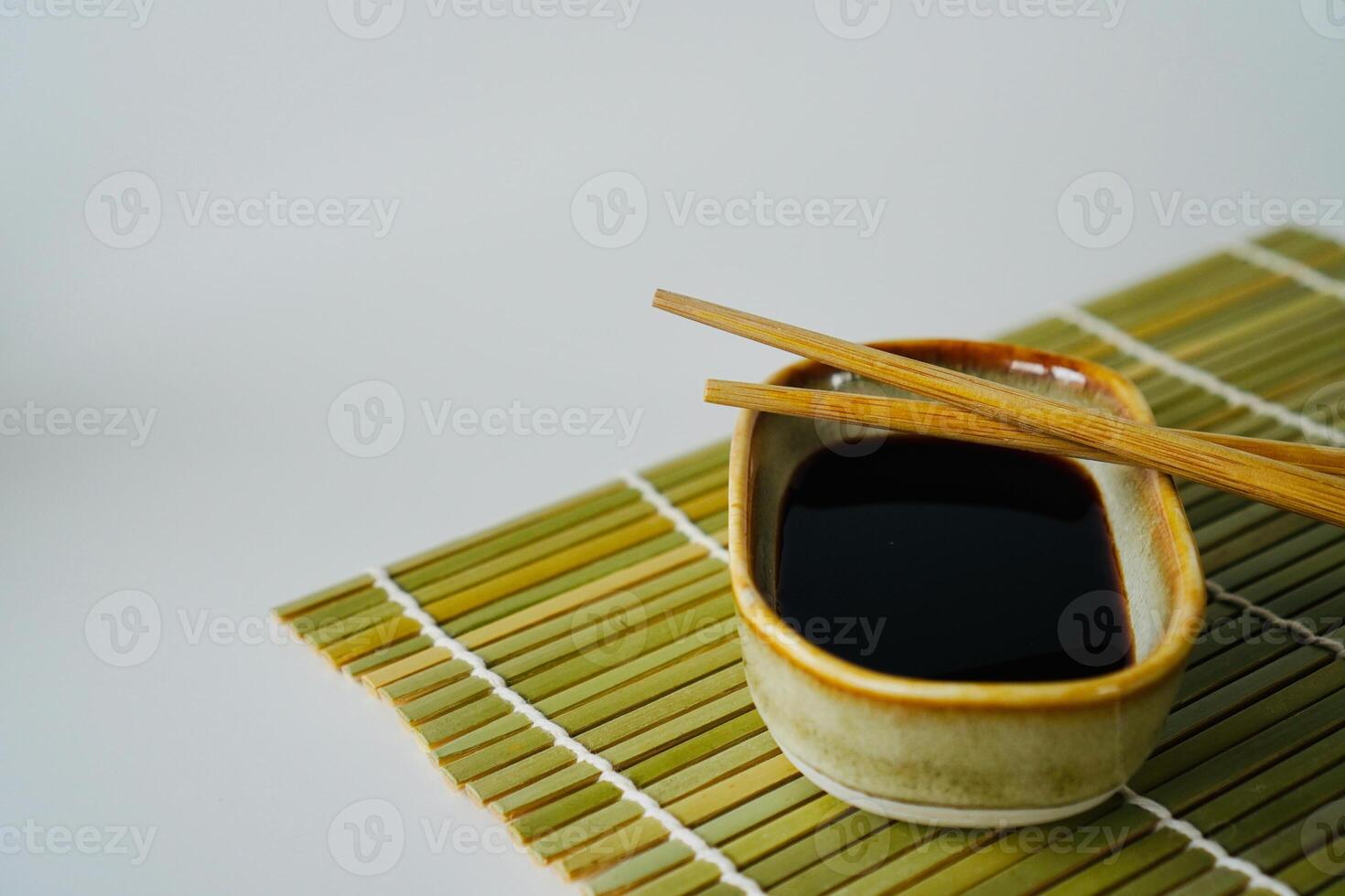 chopsticks and bowl of soy sauce photo