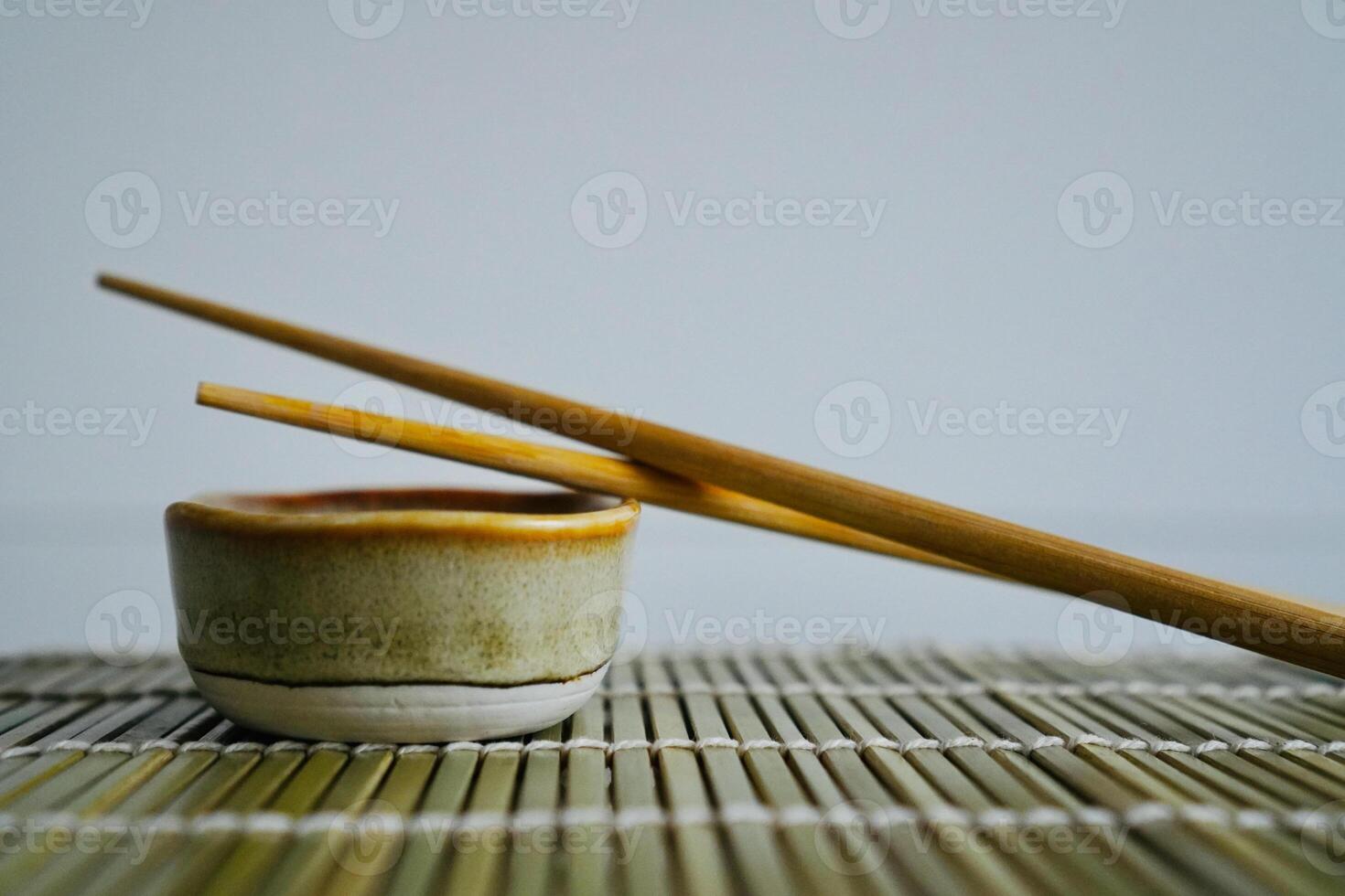 chopsticks and bowl of soy sauce photo