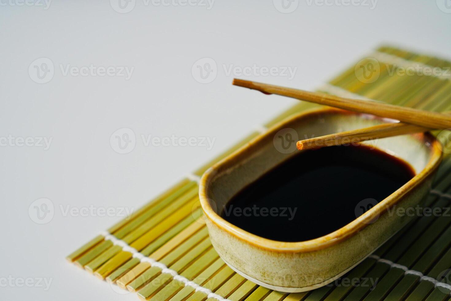 chopsticks and bowl of soy sauce photo