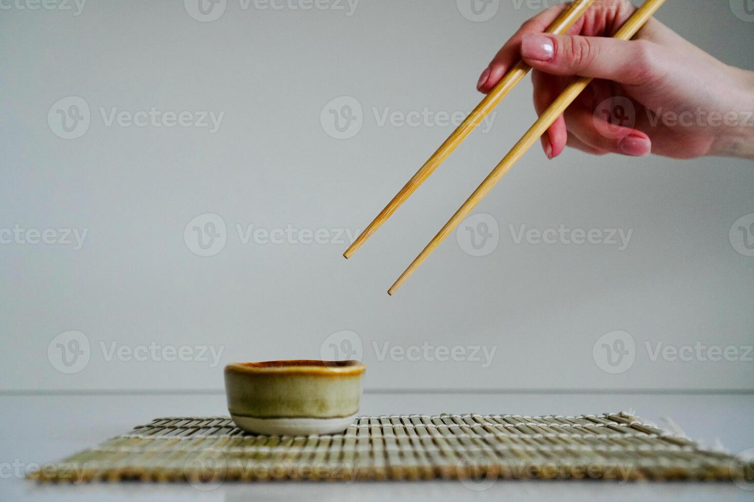 chopsticks and bowl of soy sauce photo