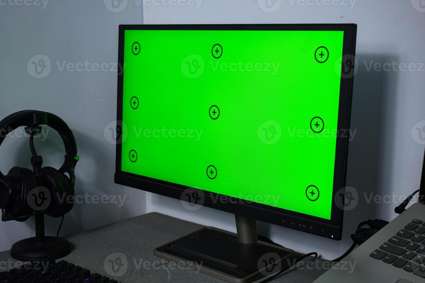 Green screen with tracking, graphic designer set up working on table photo