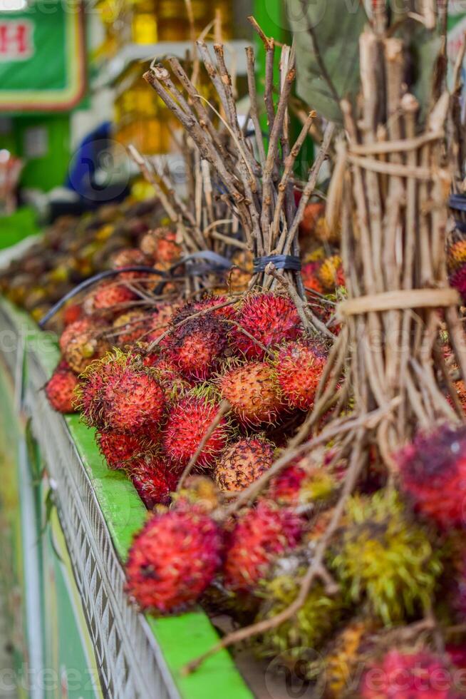 Groups of rambutan fruits displayed in supermarket box photo