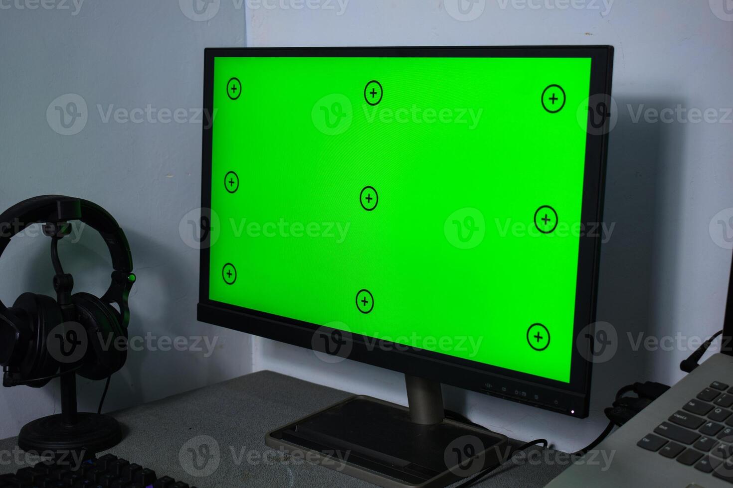 Green screen with tracking, graphic designer set up working on table photo