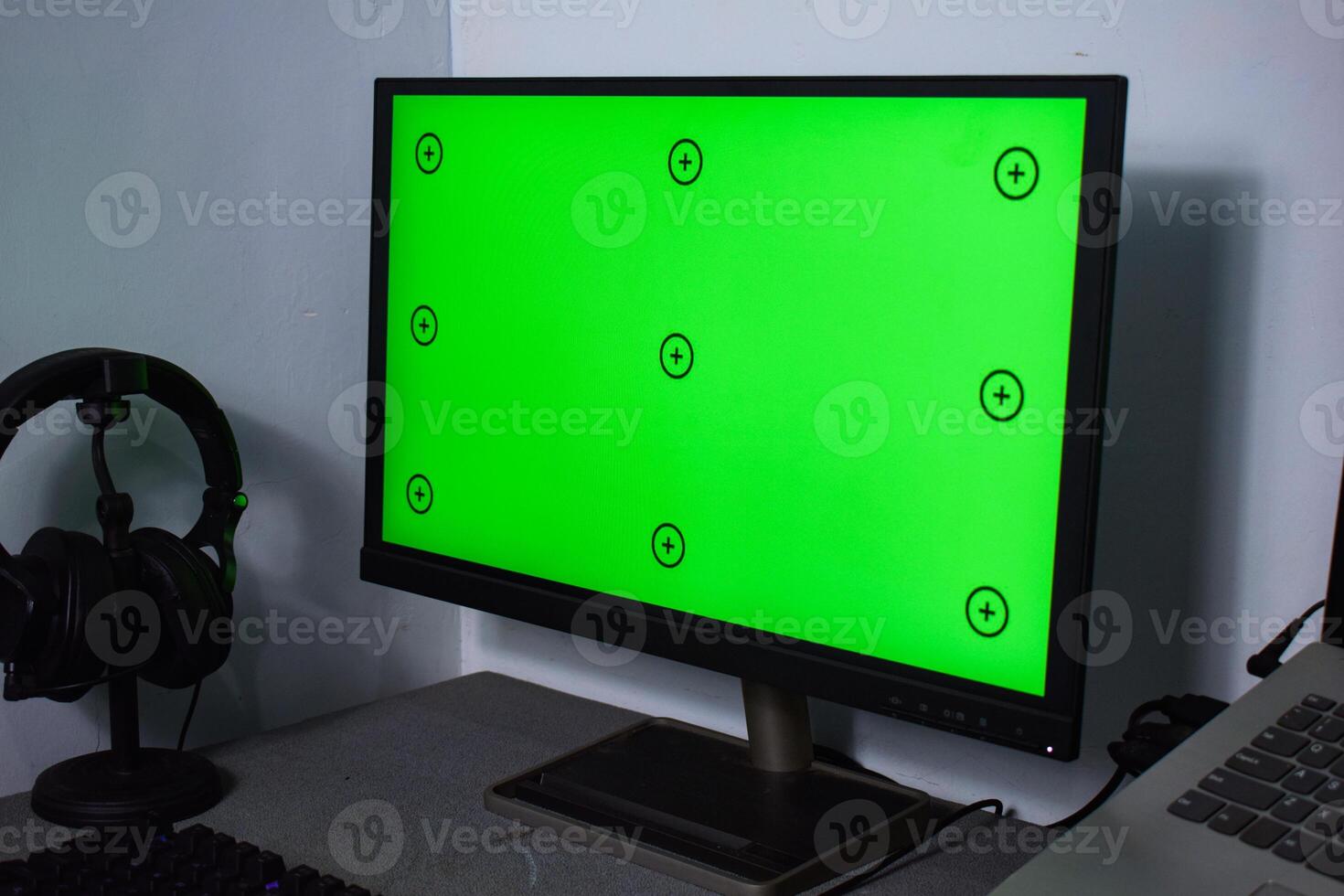 Green screen with tracking, graphic designer set up working on table photo