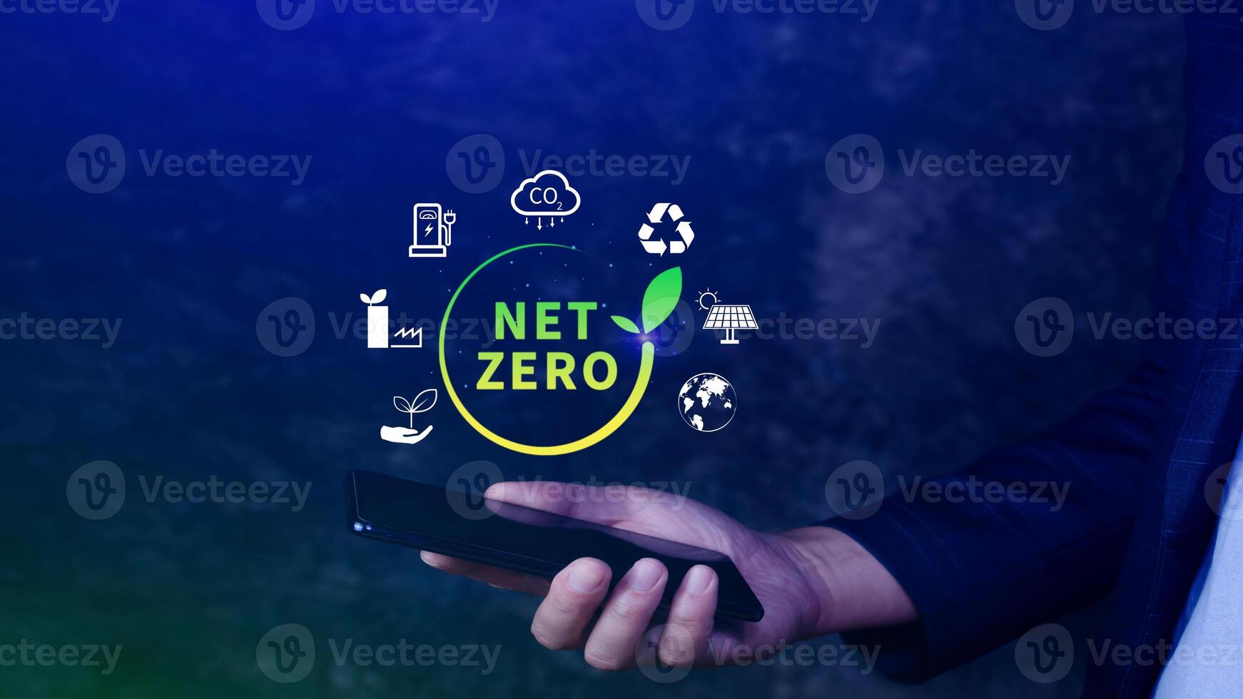 Net Zero and Carbon Neutral Concepts, Net zero greenhouse gas emissions target, Climate neutral long strategy, Businessman holding NetZero icon with smartphone. photo