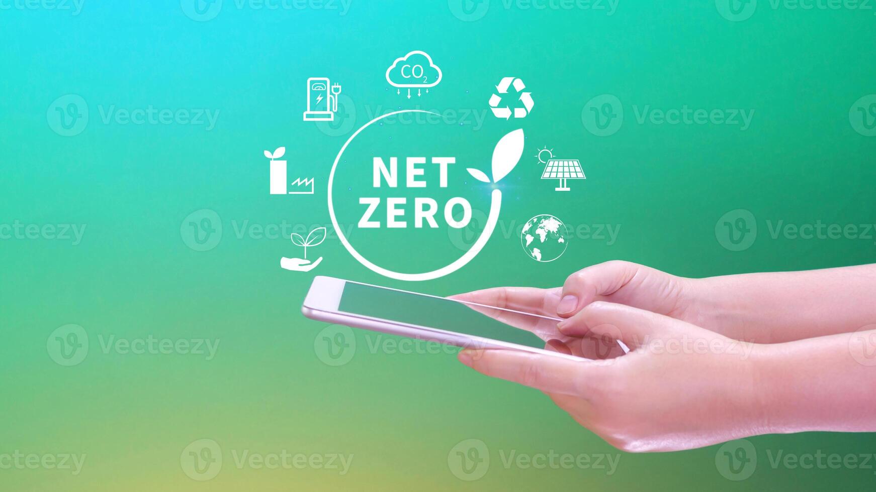 Net Zero and Carbon Neutral Concepts, Net zero greenhouse gas emissions target, Climate neutral long strategy, Businessman holding NetZero icon with smartphone. photo
