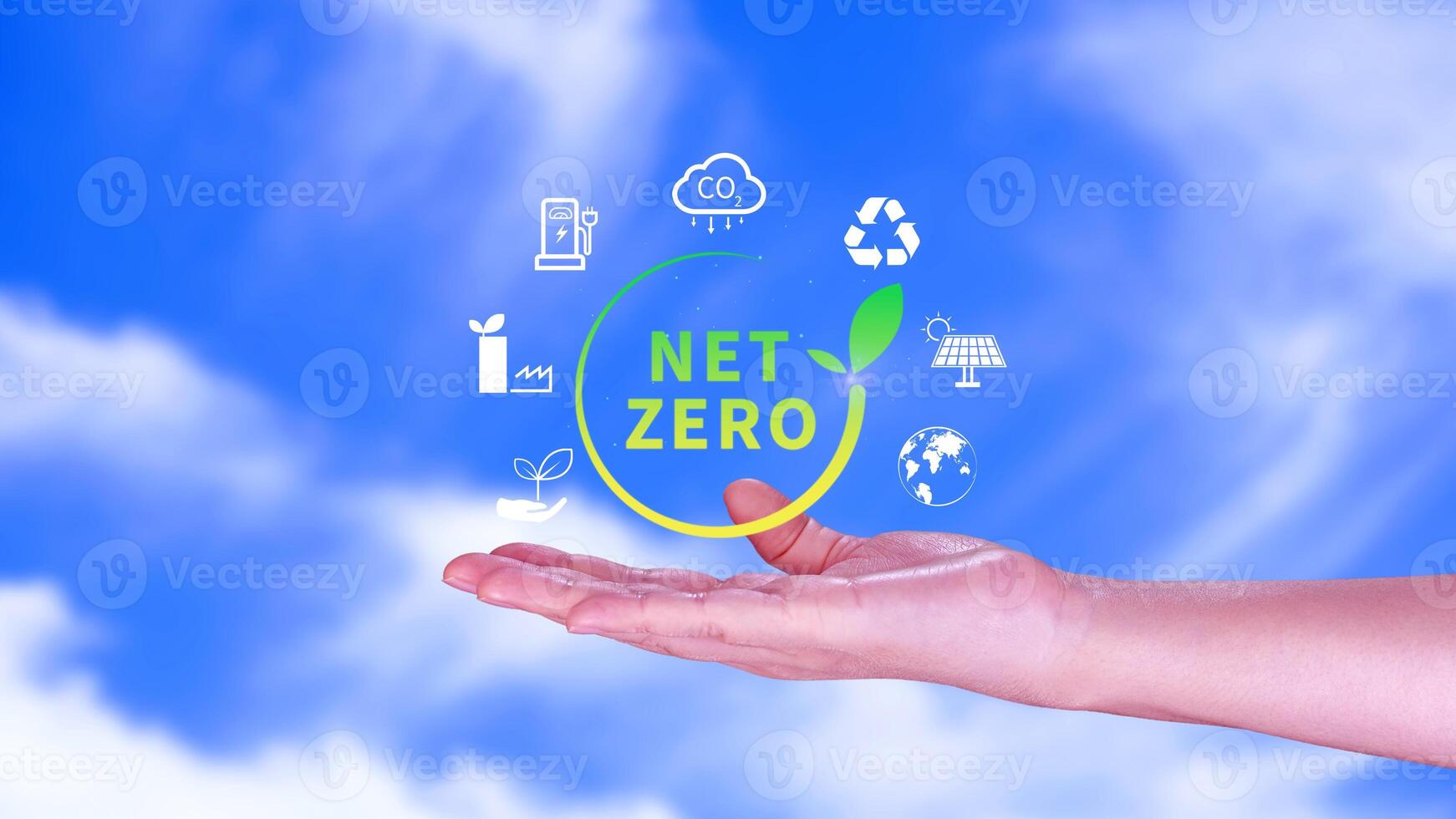 Net Zero and Carbon Neutral Concepts, Net zero greenhouse gas emissions target, Climate neutral long strategy, Businessman holding NetZero icon. photo