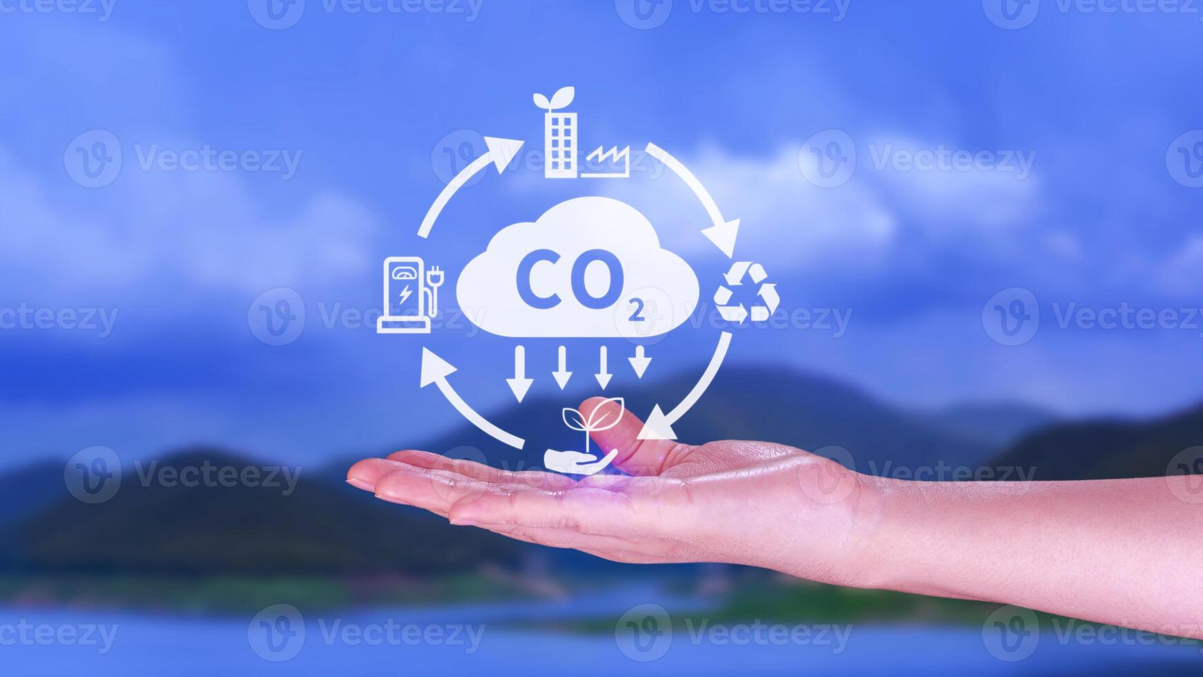 Hand holding CO2 reducing virtual icon for decrease carbon dioxide emission, carbon footprint and carbon credit to limit global warming from Bio climate change concept. photo