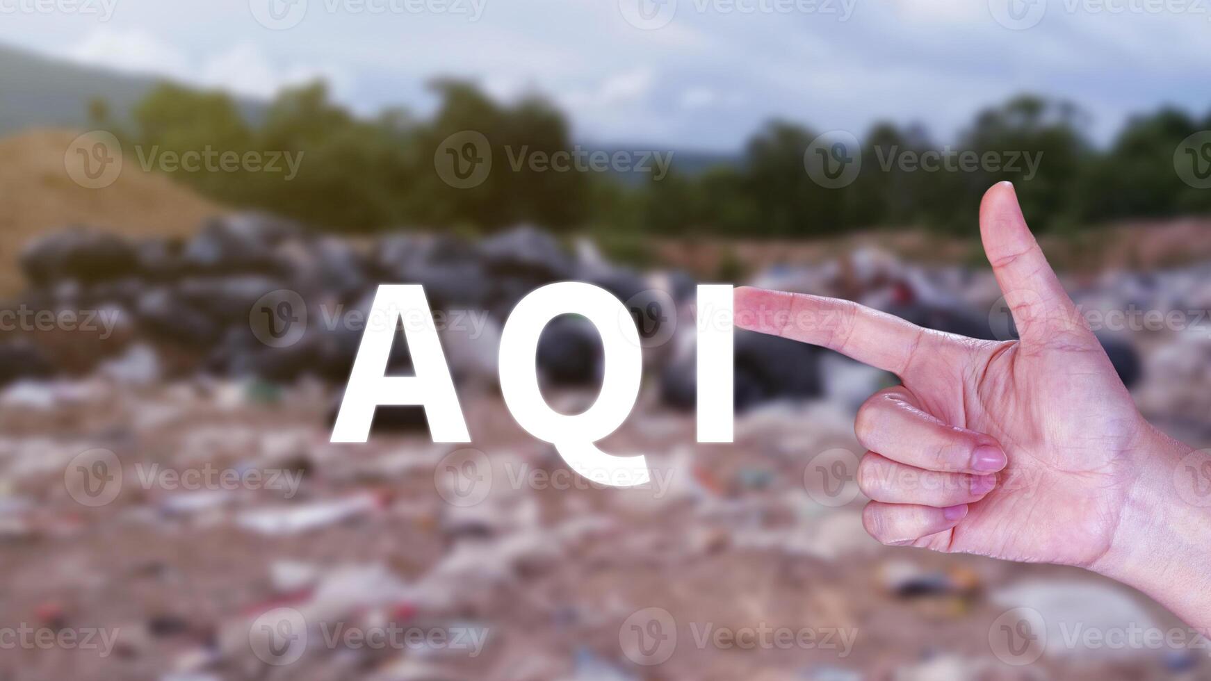 AQI, Abbreviation of air quality index, hand holding AQI on nature background, environment concept. photo