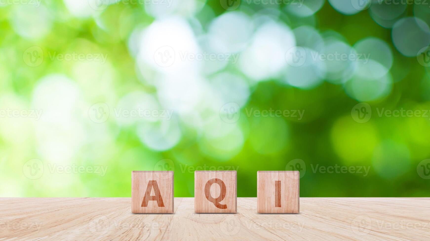 AQI, Abbreviation of air quality index word written on wooden blocks. text AQI on nature background, environment concept. photo