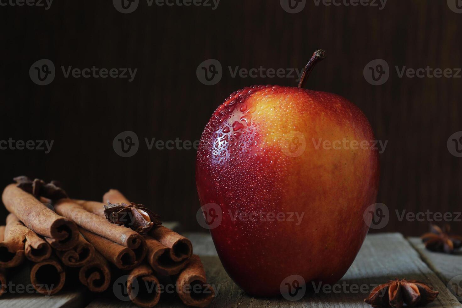 Red apple, anise and vanilla on the table photo