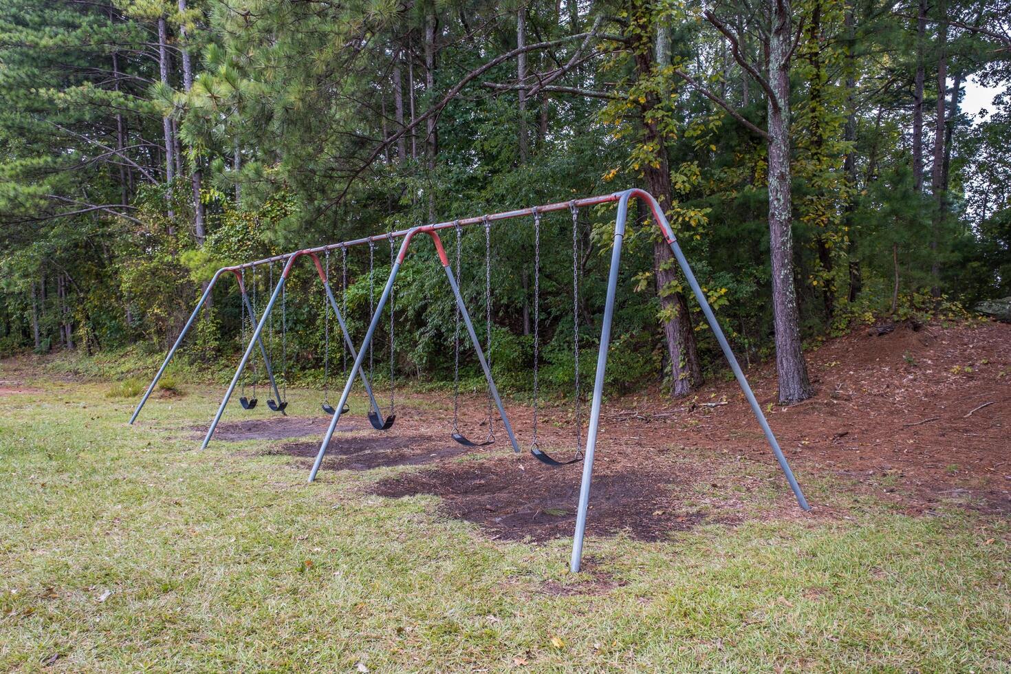 Empty playground swing set at the park photo