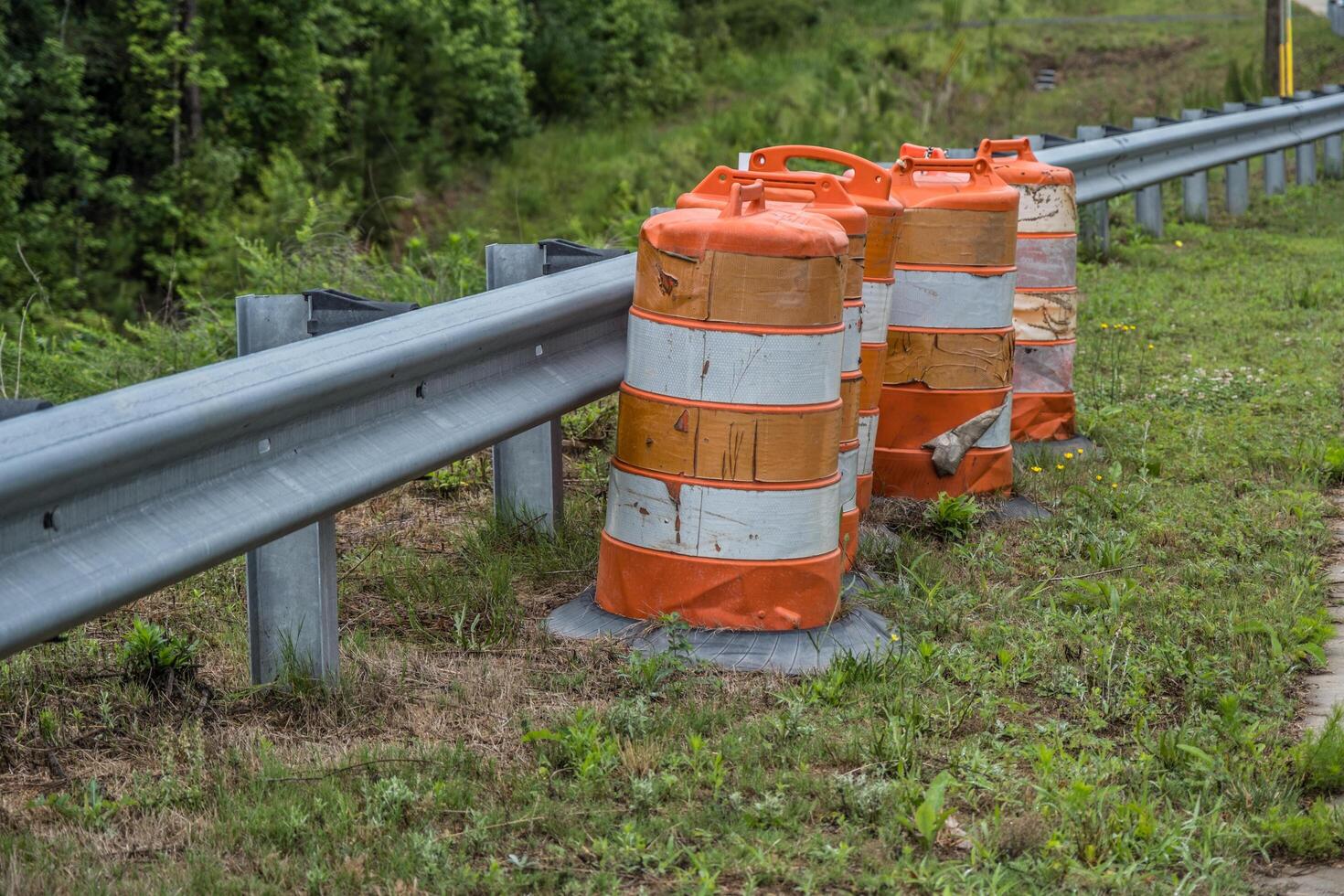 Construction barrels alongside a guardrail photo