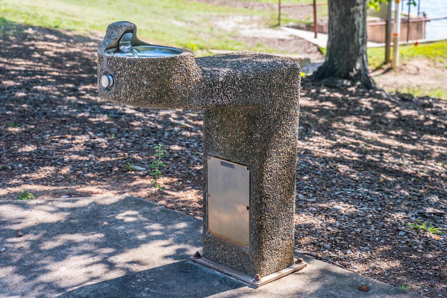 Stone covered drinking water fountain photo