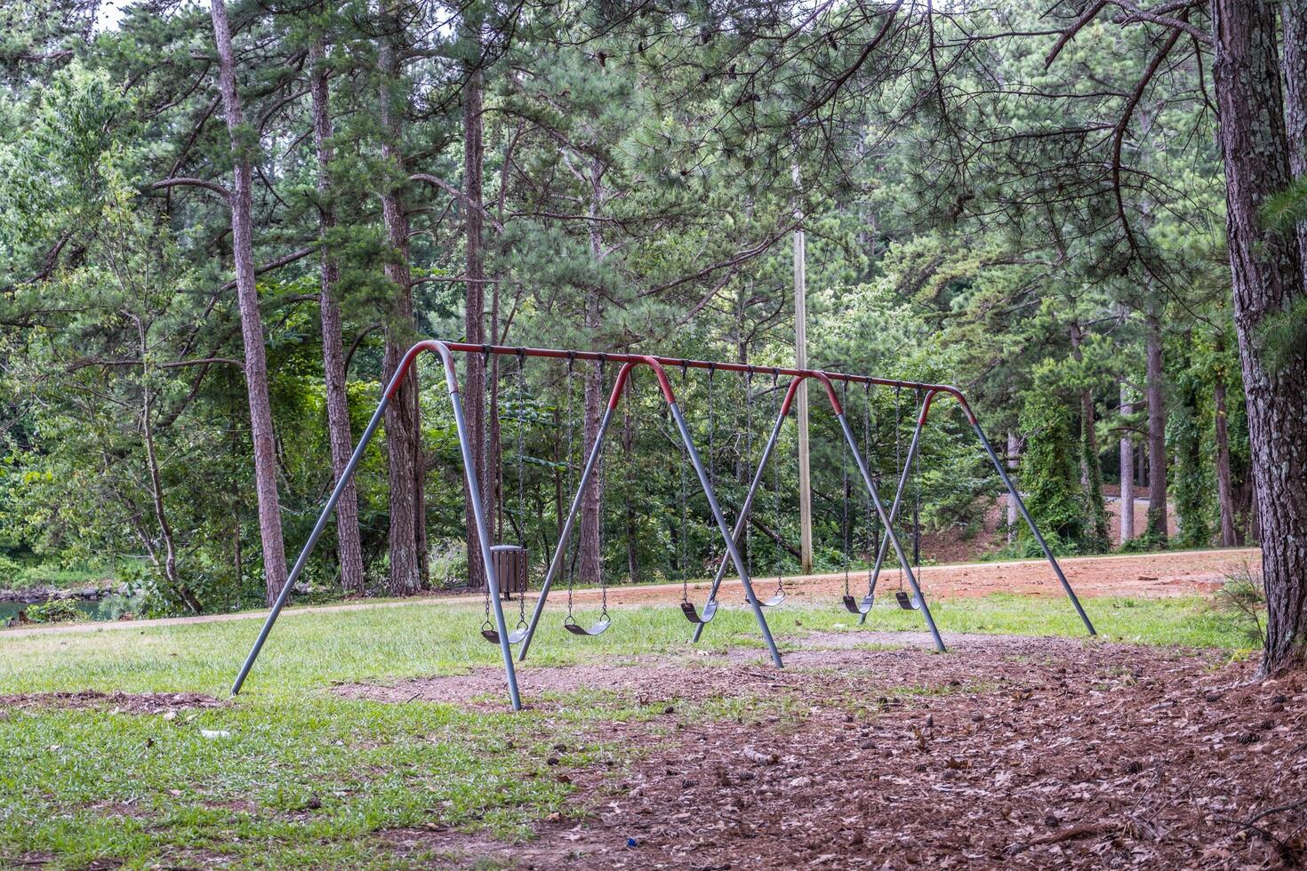 Old worn swing set in the park photo