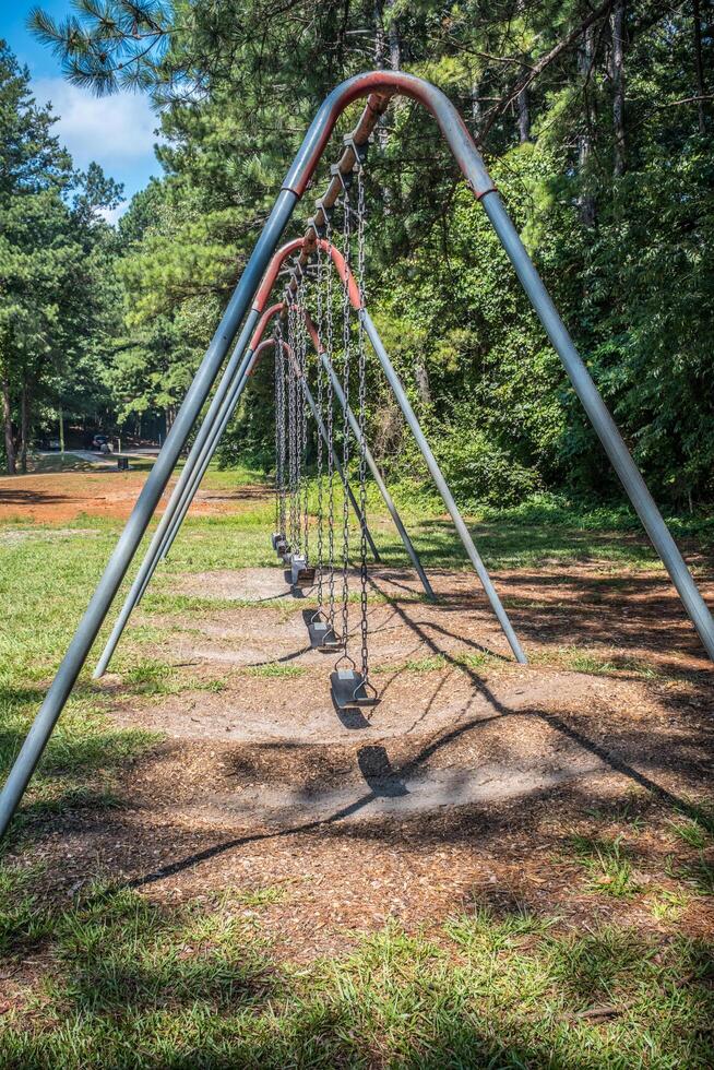 Playground swing set at the park photo