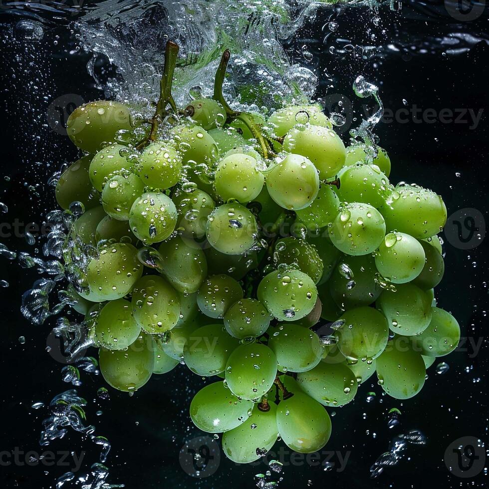 Green grapes falling in water with splash on black background. photo