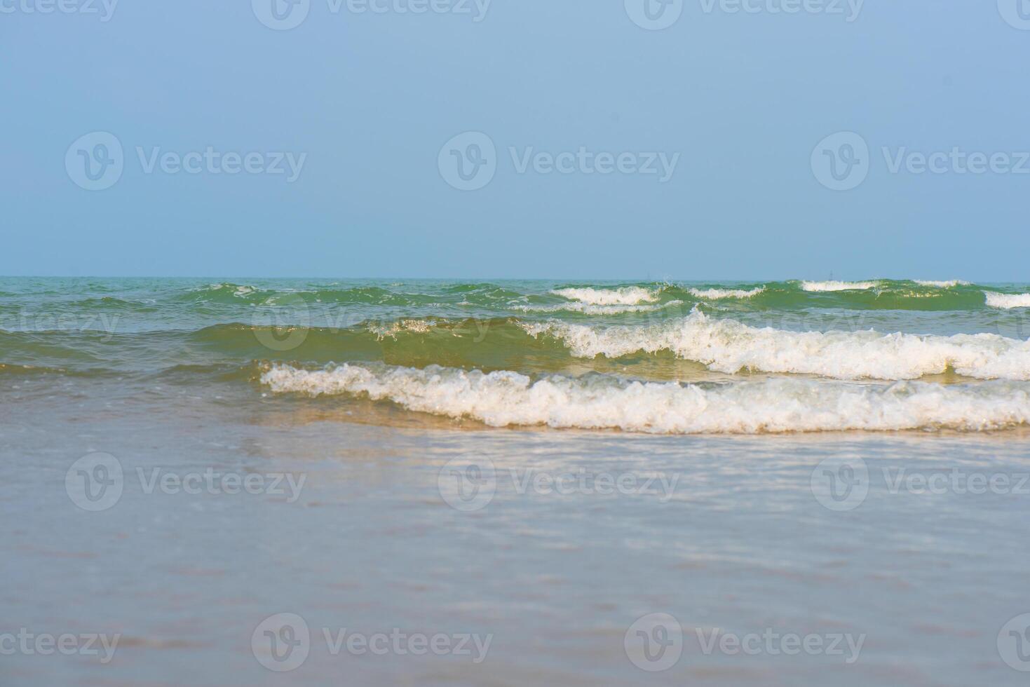 Blue sea waves on the surface ripples blurred. Defocus blurred transparent blue colored clear calm water surface texture with splash and bubbles. Water waves with shining pattern texture background. photo