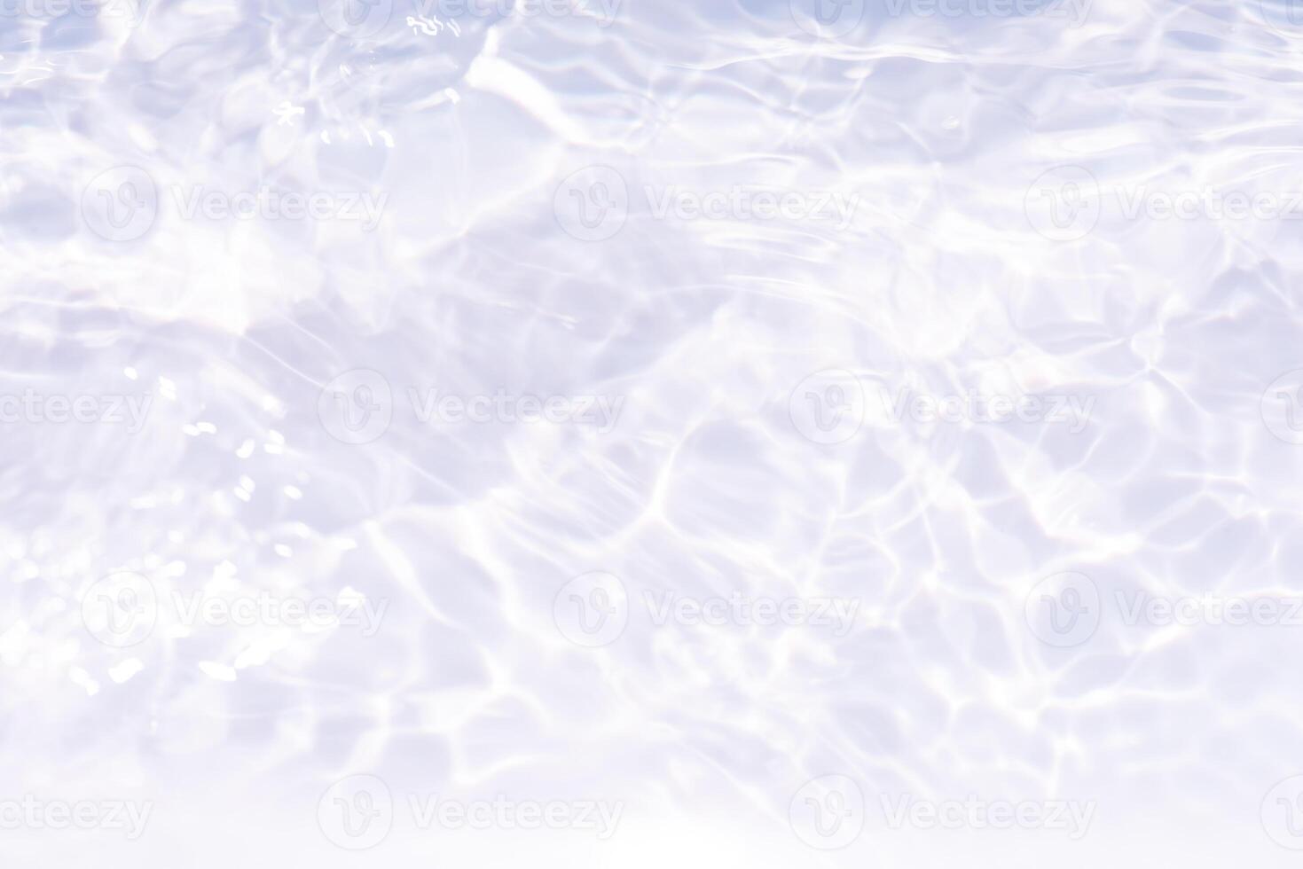Bluewater waves on the surface ripples blurred. Defocus blurred transparent blue colored clear calm water surface texture with splash and bubbles. Water waves with shining pattern texture background. photo