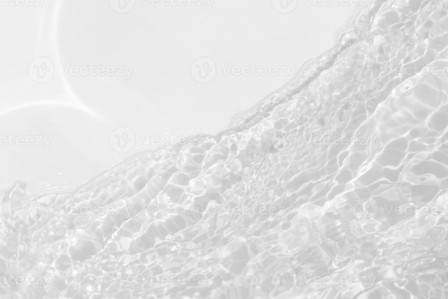 Bluewater waves on the surface ripples blurred. Defocus blurred transparent blue colored clear calm water surface texture with splash and bubbles. Water waves with shining pattern texture background. photo