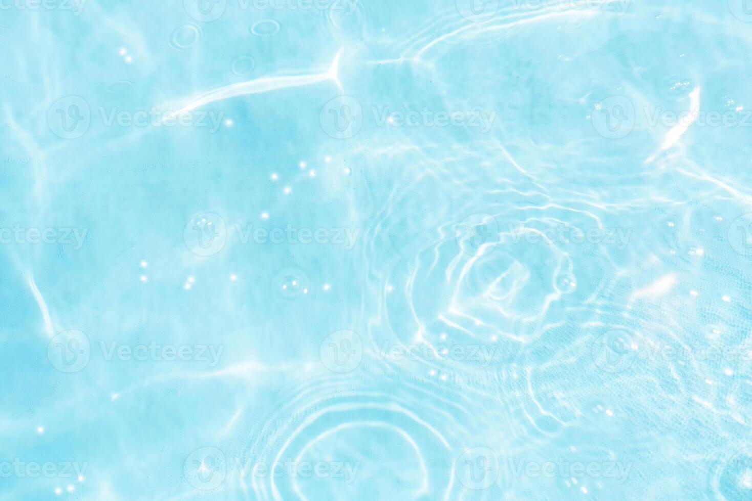 Bluewater waves on the surface ripples blurred. Defocus blurred transparent blue colored clear calm water surface texture with splash and bubbles. Water waves with shining pattern texture background. photo