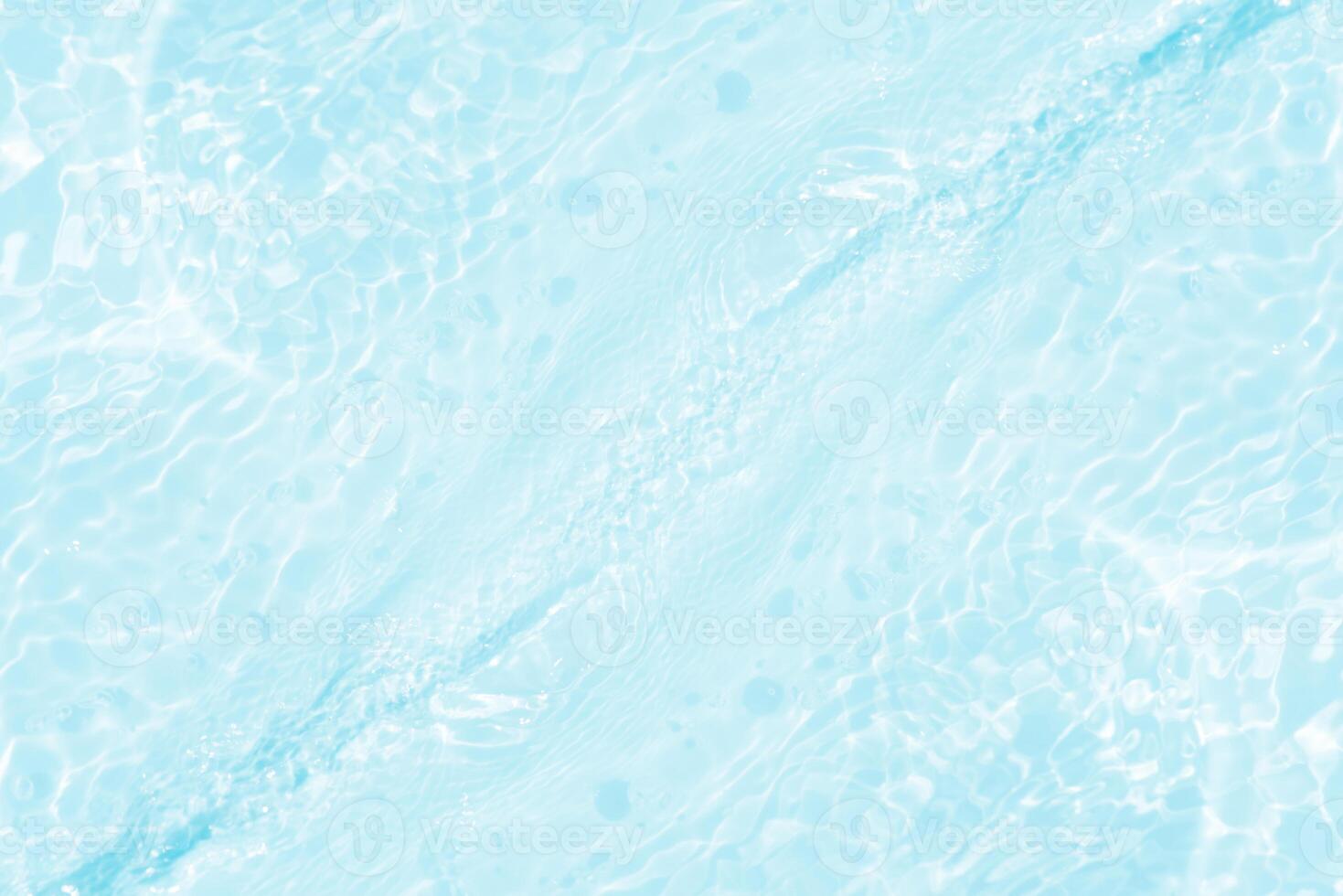 Bluewater waves on the surface ripples blurred. Defocus blurred transparent blue colored clear calm water surface texture with splash and bubbles. Water waves with shining pattern texture background. photo
