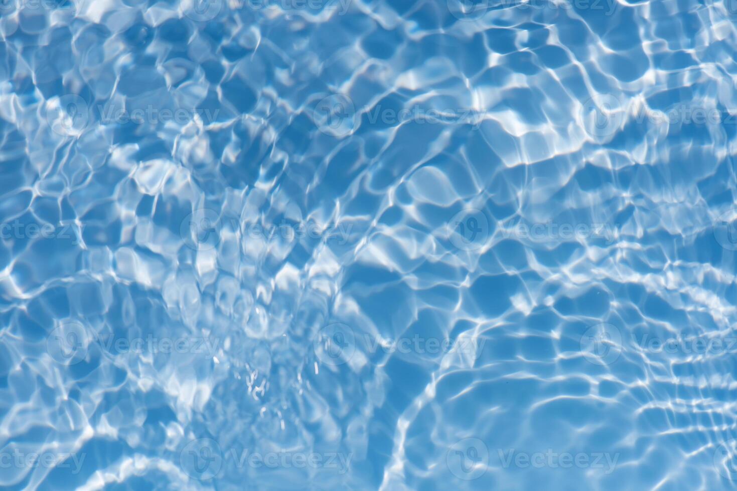 Bluewater waves on the surface ripples blurred. Defocus blurred transparent blue colored clear calm water surface texture with splash and bubbles. Water waves with shining pattern texture background. photo