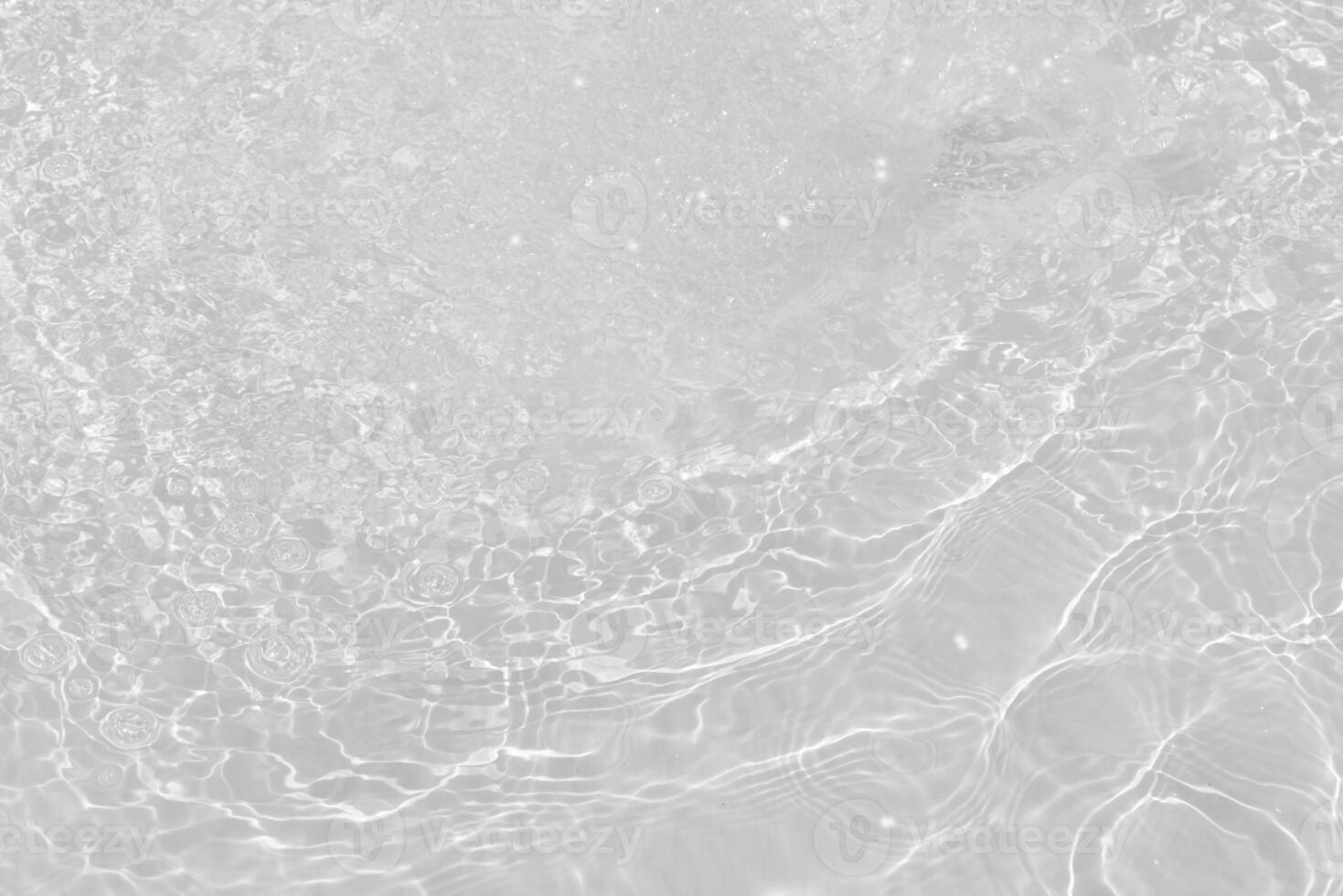 Bluewater waves on the surface ripples blurred. Defocus blurred transparent blue colored clear calm water surface texture with splash and bubbles. Water waves with shining pattern texture background. photo