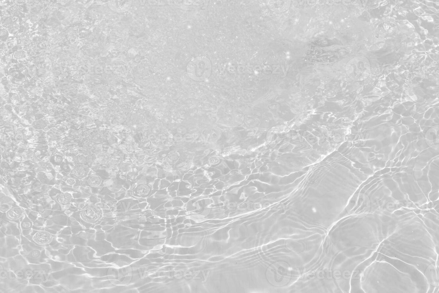 Bluewater waves on the surface ripples blurred. Defocus blurred transparent blue colored clear calm water surface texture with splash and bubbles. Water waves with shining pattern texture background. photo