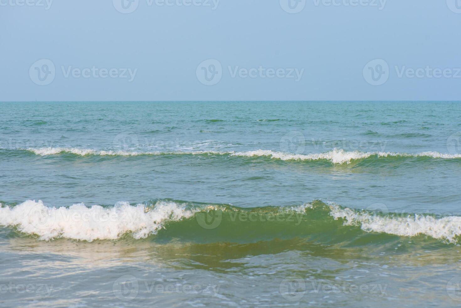 Blue sea waves on the surface ripples blurred. Defocus blurred transparent blue colored clear calm water surface texture with splash and bubbles. Water waves with shining pattern texture background. photo