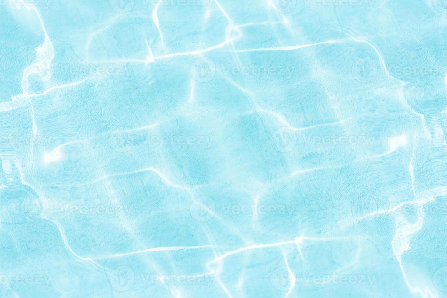Bluewater waves on the surface ripples blurred. Defocus blurred transparent blue colored clear calm water surface texture with splash and bubbles. Water waves with shining pattern texture background. photo