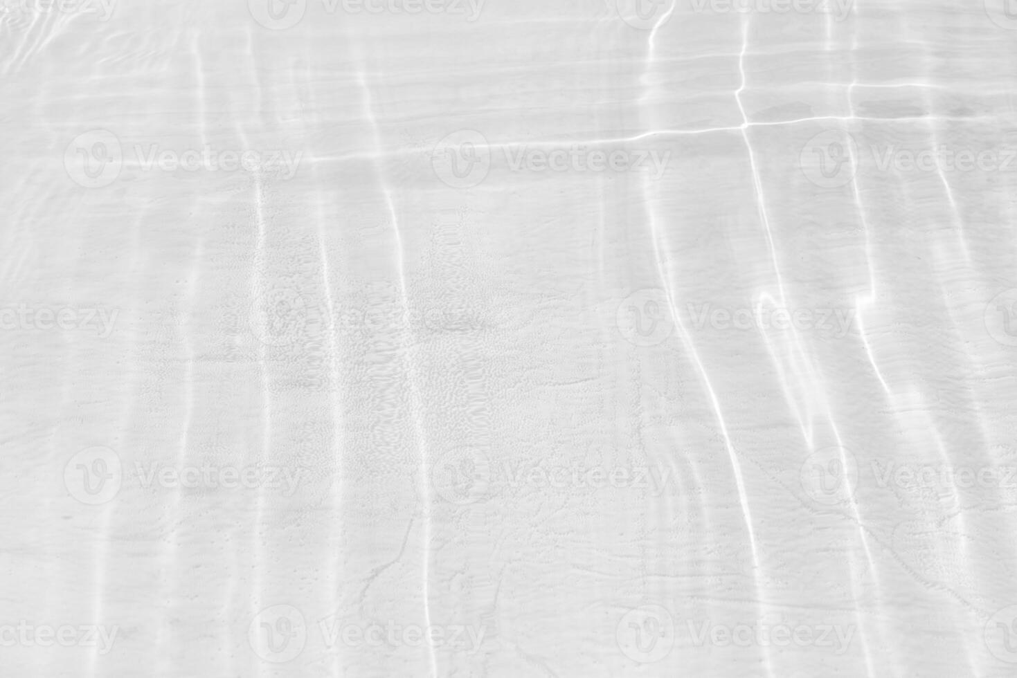 Bluewater waves on the surface ripples blurred. Defocus blurred transparent blue colored clear calm water surface texture with splash and bubbles. Water waves with shining pattern texture background. photo