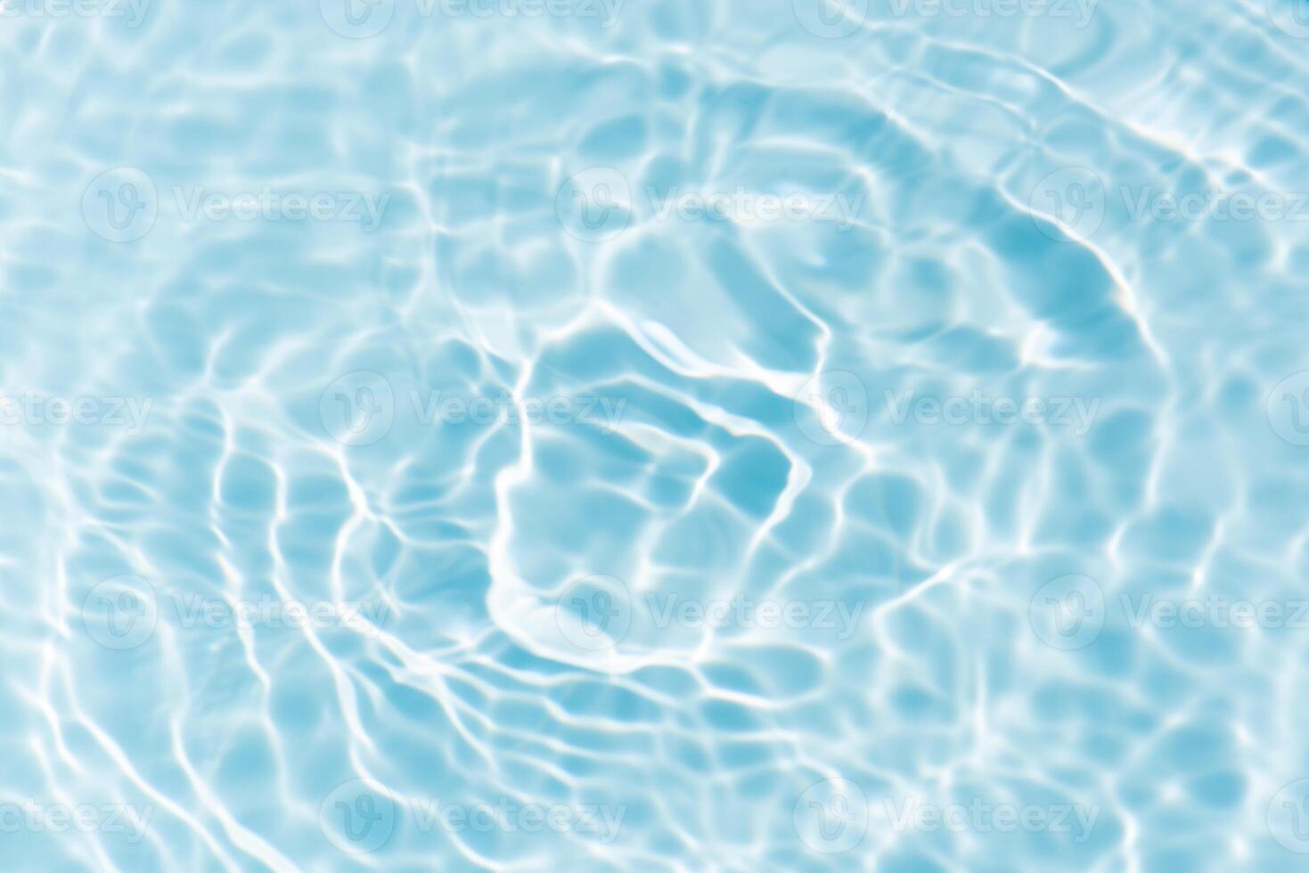 Bluewater waves on the surface ripples blurred. Defocus blurred transparent blue colored clear calm water surface texture with splash and bubbles. Water waves with shining pattern texture background. photo