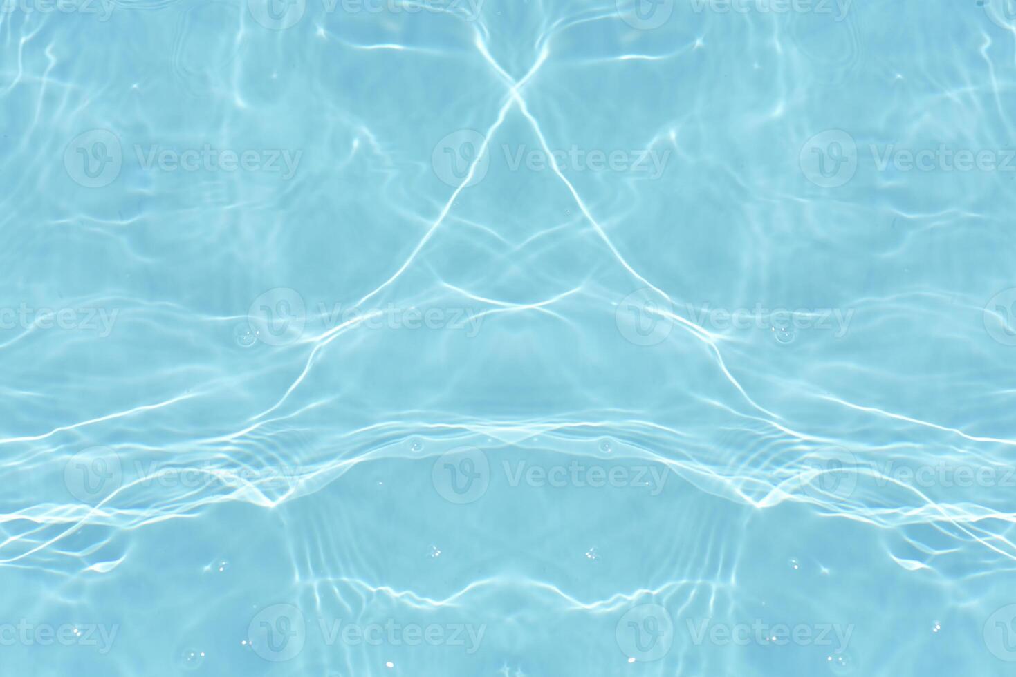 Bluewater waves on the surface ripples blurred. Defocus blurred transparent blue colored clear calm water surface texture with splash and bubbles. Water waves with shining pattern texture background. photo