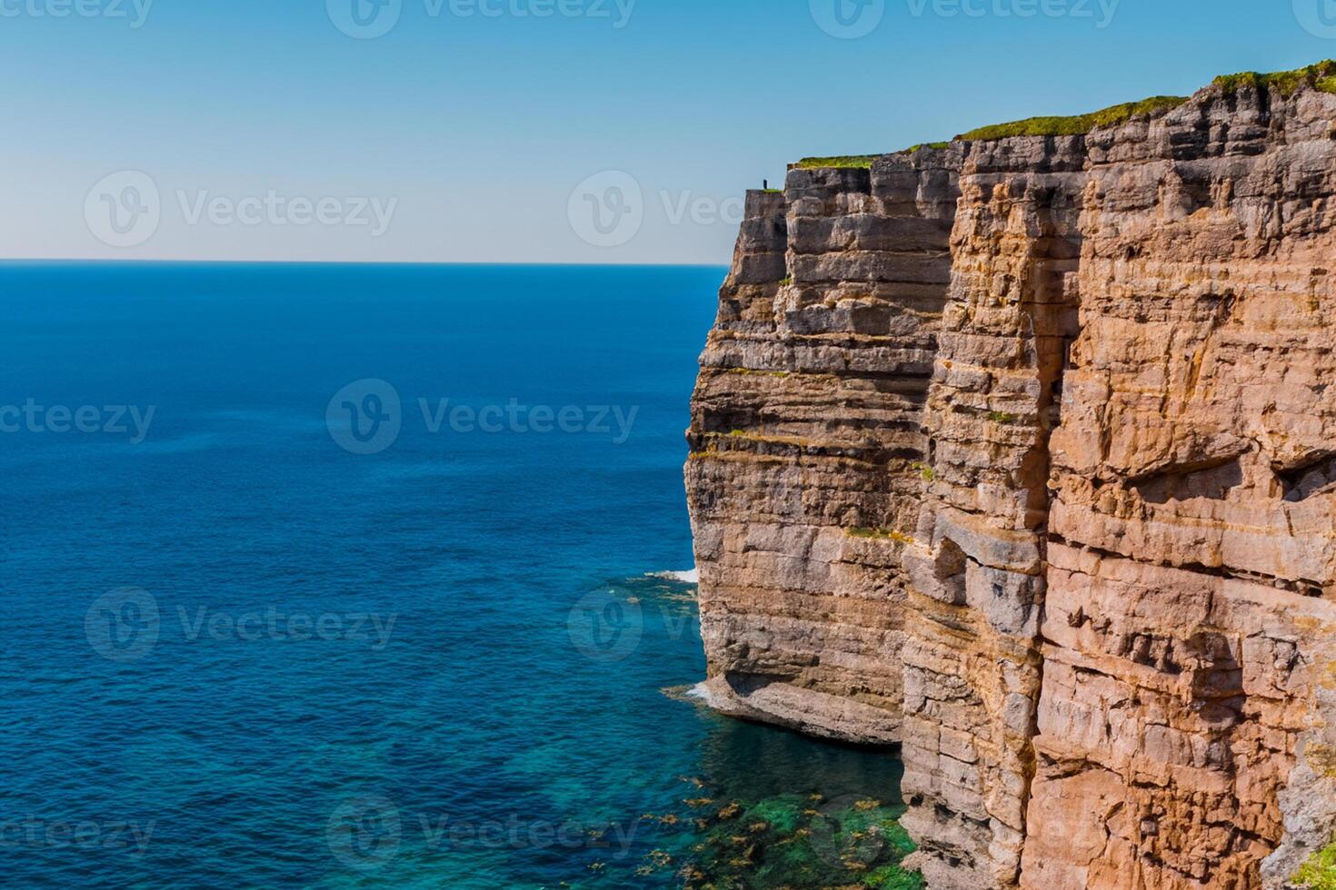 Seaside Majesty Breathtaking Coastal Cliffs Meet Stunning Blue Sea, A Spectacle of Nature's Grandeur photo