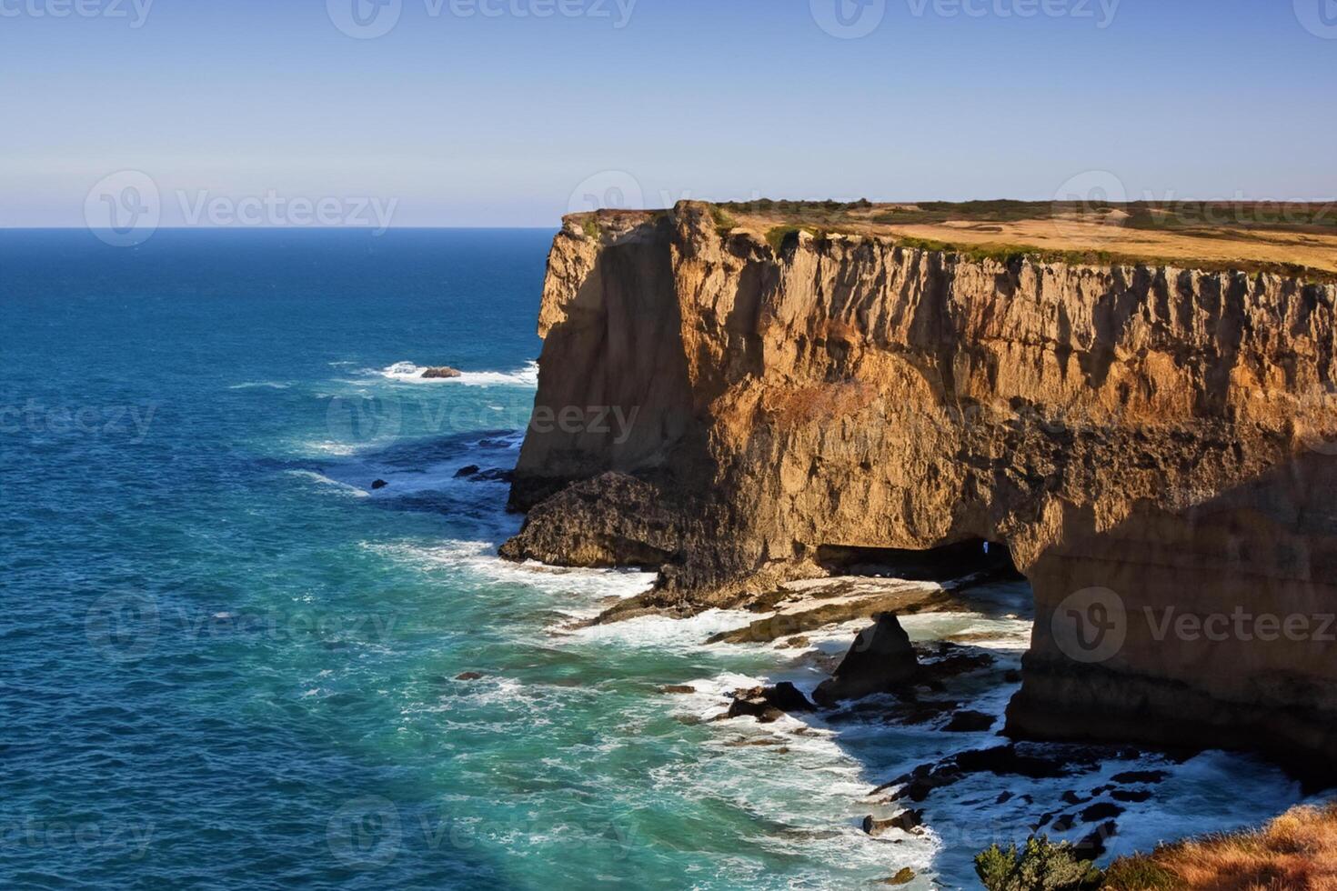 Seaside Majesty Breathtaking Coastal Cliffs Meet Stunning Blue Sea, A Spectacle of Nature's Grandeur photo