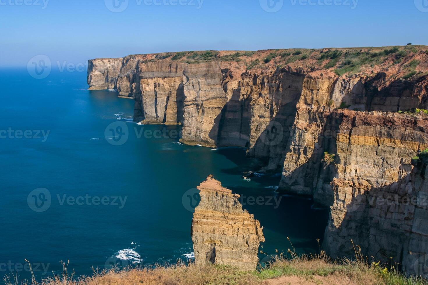 Seaside Majesty Breathtaking Coastal Cliffs Meet Stunning Blue Sea, A Spectacle of Nature's Grandeur photo