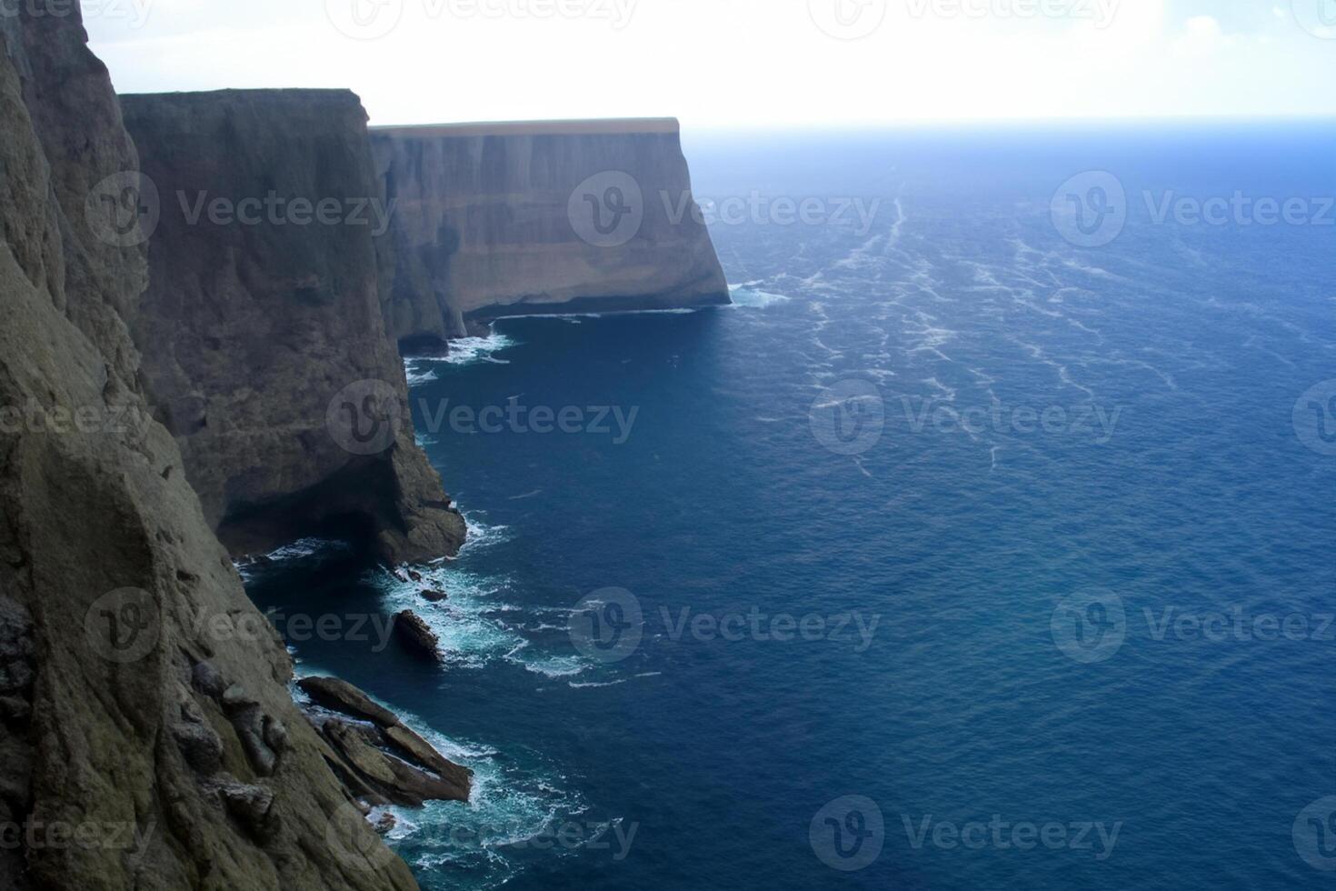 Seaside Majesty Breathtaking Coastal Cliffs Meet Stunning Blue Sea, A Spectacle of Nature's Grandeur photo