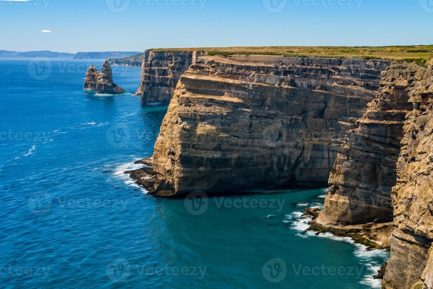 Seaside Majesty Breathtaking Coastal Cliffs Meet Stunning Blue Sea, A Spectacle of Nature's Grandeur photo