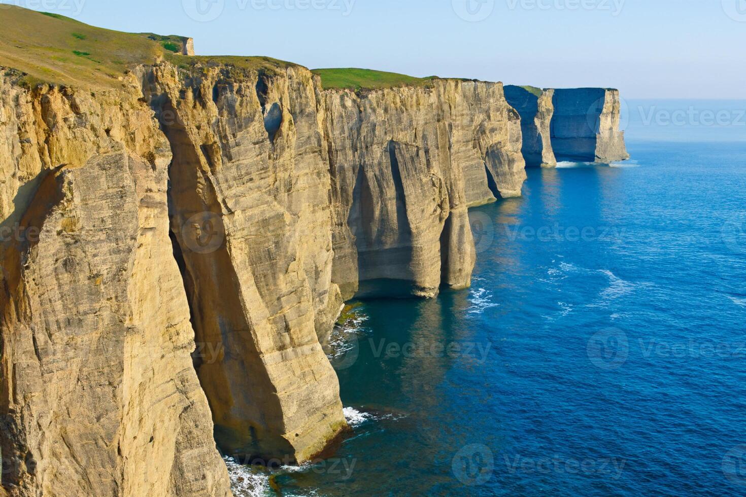 Seaside Majesty Breathtaking Coastal Cliffs Meet Stunning Blue Sea, A Spectacle of Nature's Grandeur photo