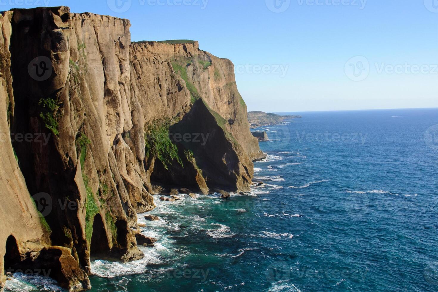 Seaside Majesty Breathtaking Coastal Cliffs Meet Stunning Blue Sea, A Spectacle of Nature's Grandeur photo