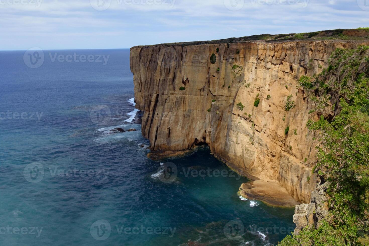 Seaside Majesty Breathtaking Coastal Cliffs Meet Stunning Blue Sea, A Spectacle of Nature's Grandeur photo