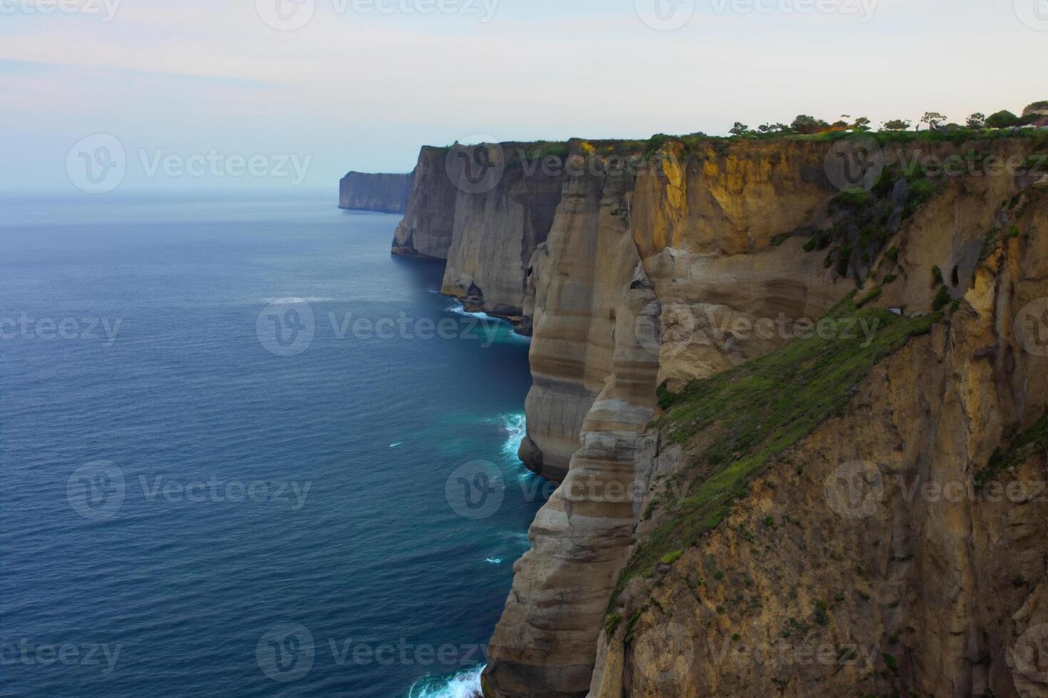 Seaside Majesty Breathtaking Coastal Cliffs Meet Stunning Blue Sea, A Spectacle of Nature's Grandeur photo