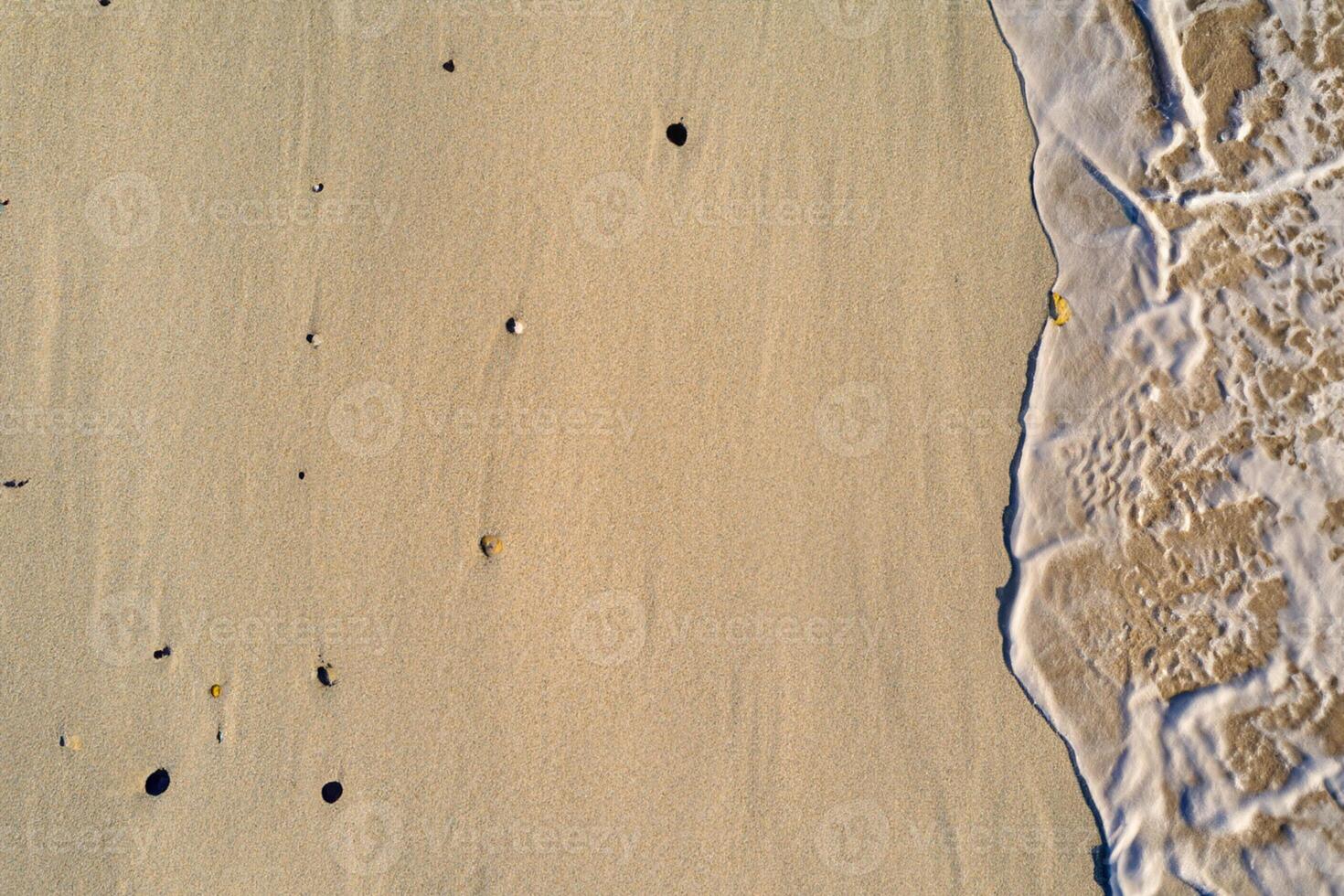 Horizon Haven Aerial Serenity Captures Beautiful Beach Sand from Above, a Tranquil Tapestry of Coastal Beauty photo