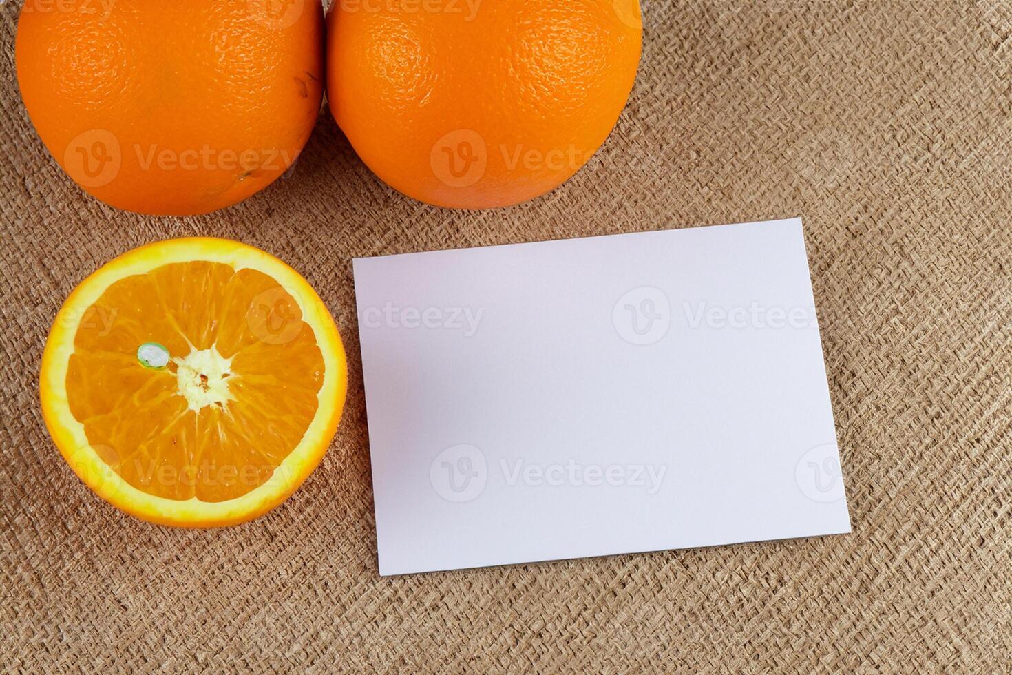 Generated imageWhite Paper Mockup Enlivened by the Zesty Aura of Fresh Oranges, Crafting a Visual Symphony of Culinary Opulence and Wholesome Design photo