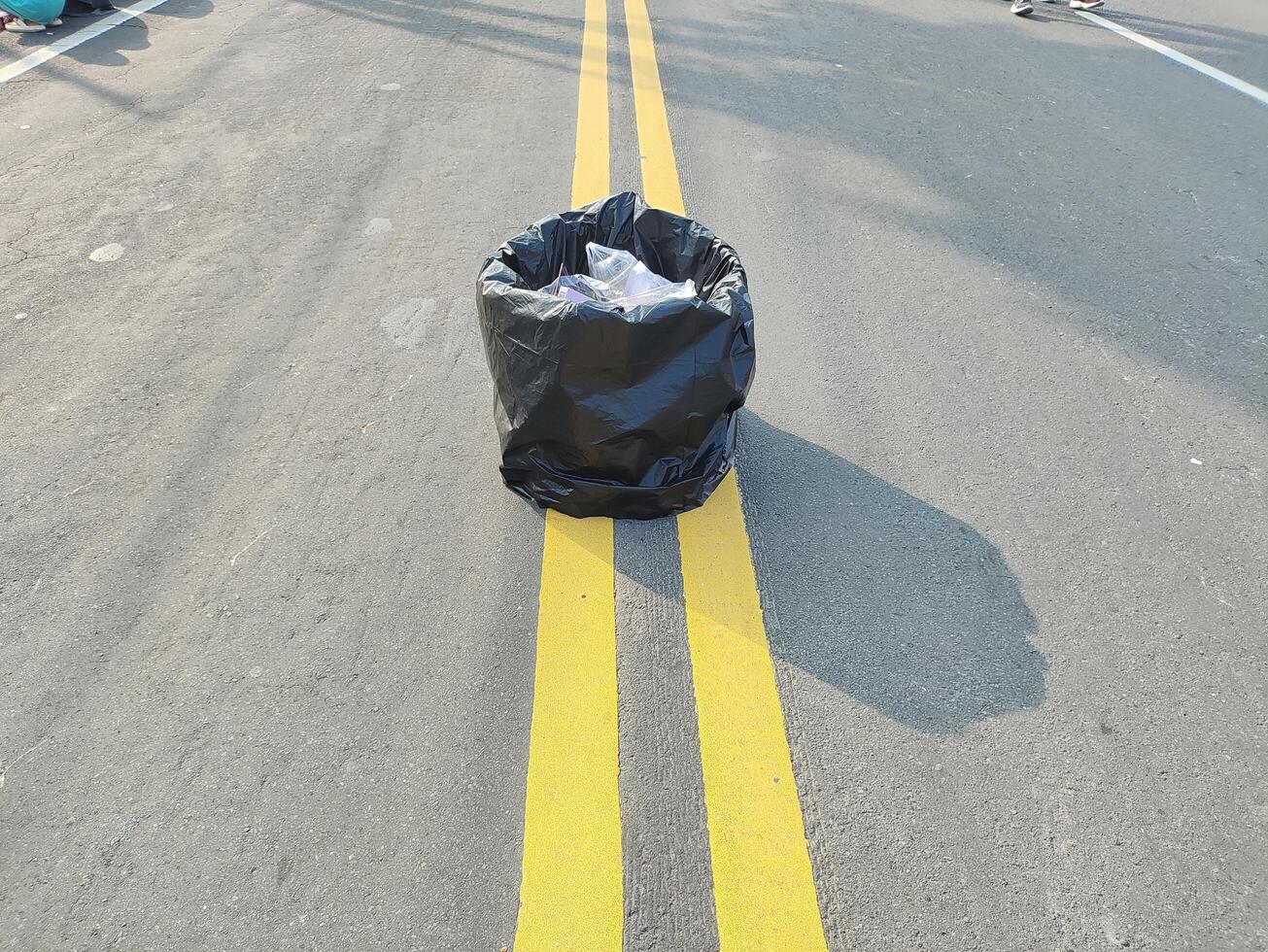 A trash can is provided in the middle of the main road during car free day in Surakarta, Indonesia photo