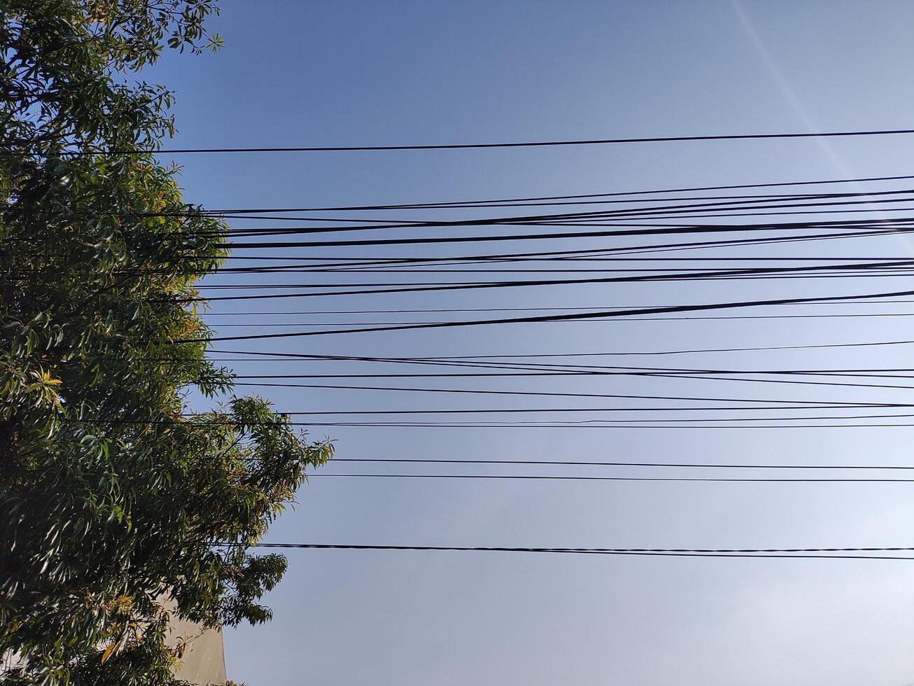 low angle view of cables against blue sky photo